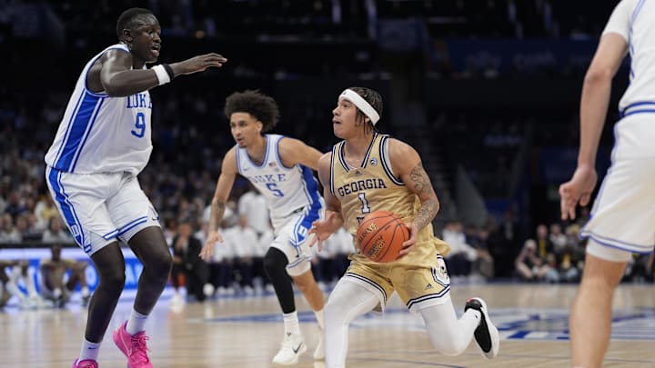 Mar 13, 2025; Charlotte, NC, USA; Georgia Tech Yellow Jackets guard Naithan George (1) drives to the basket against Duke Blue Devils center Khaman Maluach (9) during the first half at Spectrum Center. Mandatory Credit: Jim Dedmon-Imagn Images