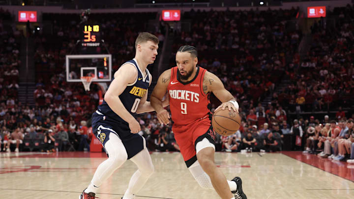 Houston Rockets forward Dillon Brooks dribbles against Denver Nuggets guard Christian Braun.