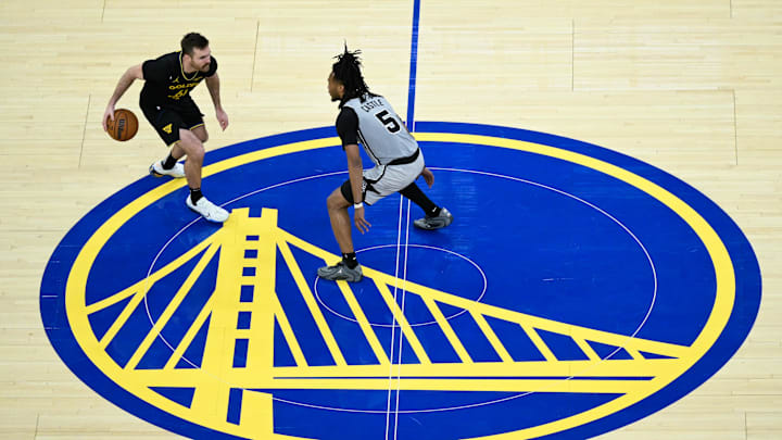 Feb 11, 2026; San Francisco, California, USA; Golden State Warriors guard Pat Spencer (61) dribbles against San Antonio Spurs guard Stephon Castle (5) in the third quarter at Chase Center. Mandatory Credit: Eakin Howard-Imagn Images