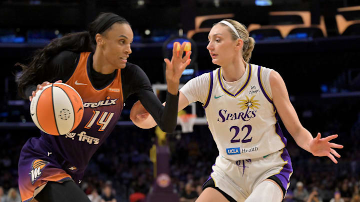 Aug 26, 2025; Los Angeles, California, USA;  Phoenix Mercury forward DeWanna Bonner (14) is defended by Los Angeles Sparks forward Cameron Brink (22) as she drives to the basket during the first half at Crypto.com Arena. Mandatory Credit: Jayne Kamin-Oncea-Imagn Images