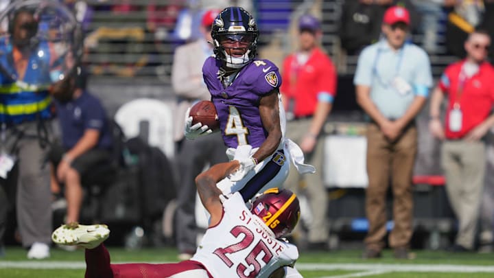 Oct 13, 2024; Baltimore, Maryland, USA; Baltimore Ravens wide receiver Zay Flowers (4) catches a pass defended by Washington Commanders cornerback Benjamin St-Juste (25) during the second quarter at M&T Bank Stadium. Mandatory Credit: Mitch Stringer-Imagn Images