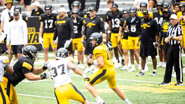 Aug 9, 2025; Iowa quarterback Mark Gronowski (11) drops back to pass during the Hawkeyes Kids Day NCAA football open practice at Kinnick Stadium in Iowa City, Iowa. Mandatory Credit: Joseph Cress for the Des Moines Register