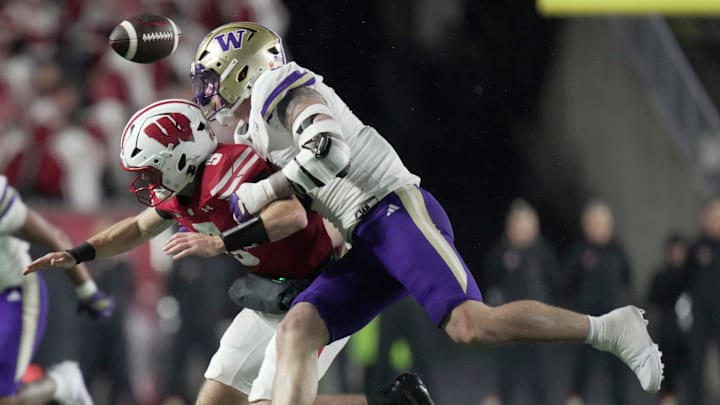Washington linebacker Zach Durfee (5) forces a fumble by Wisconsin quarterback Carter Smith (5) during the third quarter of their game Saturday, November 8, 2025 at Camp Randall Stadium in Madison, Wisconsin. Wisconsin beat Washington 13-10. Wisconsin recovered the ball.
