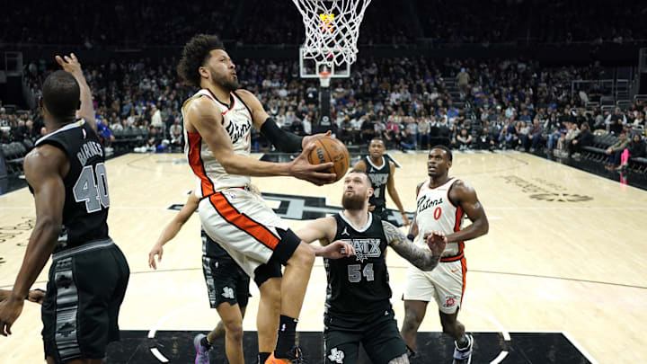 Feb 21, 2025; Austin, Texas, USA; Detroit Pistons guard Cade Cunningham (2) drives to the basket between San Antonio Spurs forwards Harrison Barnes (40) and Sandro Mamukelashvili (54) during the second half at Moody Center. Mandatory Credit: Scott Wachter-Imagn Images