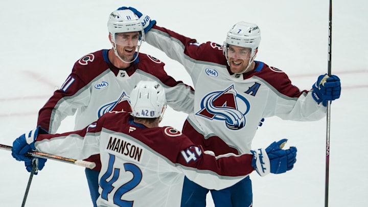 Apr 19, 2025; Dallas, Texas, USA; Colorado Avalanche defenseman Devon Toews (7) celebrates with center Brock Nelson (11) and defenseman Josh Manson (42) after scoring a goal against the Dallas Stars during the third period in game one of the first round of the 2025 Stanley Cup Playoffs at American Airlines Center. Mandatory Credit: Raymond Carlin III-Imagn Images