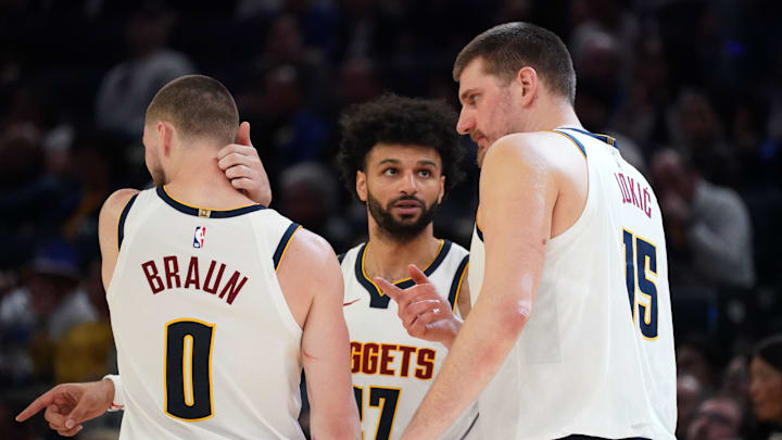 Feb 22, 2026; San Francisco, California, USA;  Denver Nuggets guard Jamal Murray (27) talks with guard Christian Braun (0) and center Nikola Jokic (15) in the fourth quarter against the Golden State Warriors at Chase Center.