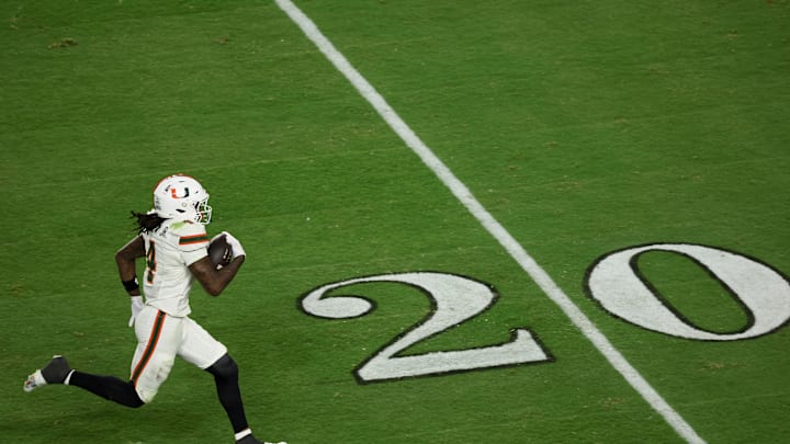 Jan 19, 2026; Miami Gardens, FL, USA; Miami Hurricanes running back Mark Fletcher Jr. (4) carries the ball for a touchdown against the Indiana Hoosiers in the third quarter during the College Football Playoff National Championship game at Hard Rock Stadium. Mandatory Credit: Kim Klement Neitzel-Imagn Images
