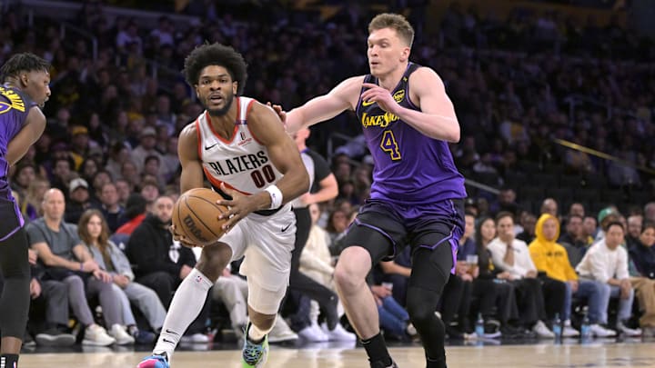 Jan 2, 2025; Los Angeles, California, USA; Portland Trail Blazers guard Scoot Henderson (00) drives past Los Angeles Lakers guard Dalton Knecht (4) in the first half at Crypto.com Arena. Mandatory Credit: Jayne Kamin-Oncea-Imagn Images