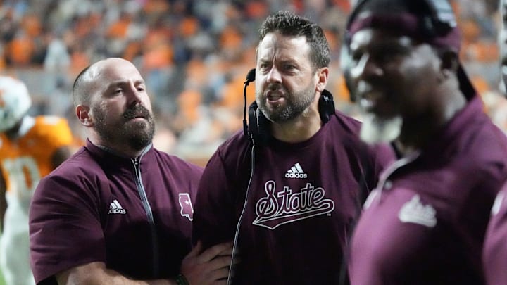 Nov 9, 2024; Knoxville, Tennessee, USA; Mississippi State Bulldogs defensive coordinator Coleman Hutzler is held back by assistant coach Matt Holecek as yells at officials as on a pass interference call  against the Tennessee Volunteers during the second half at Neyland Stadium. Mandatory Credit: Saul Young/USA TODAY Network via Imagn Images