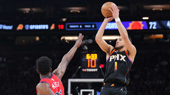 Feb 28, 2025; Phoenix, Arizona, USA; Phoenix Suns guard Devin Booker (1) shoots against New Orleans Pelicans center Yves Missi (21) during the second half at Footprint Center. Mandatory Credit: Joe Camporeale-Imagn Images