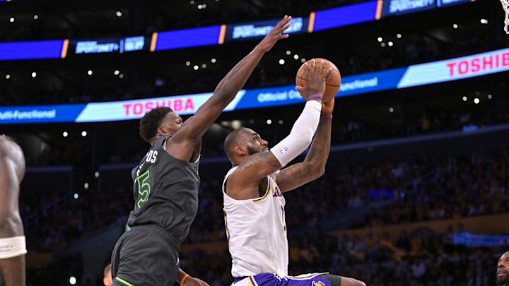 Apr 19, 2025; Los Angeles, California, USA; Los Angeles Lakers forward LeBron James (23) is fouled by Minnesota Timberwolves guard Anthony Edwards (5) as he goes up for a basket in the first half at Crypto.com Arena. Mandatory Credit: Jayne Kamin-Oncea-Imagn Images