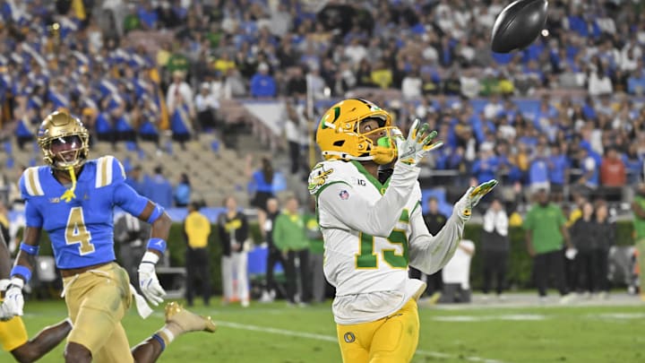 Sep 28, 2024; Pasadena, California, USA; Oregon Ducks wide receiver Tez Johnson (15) hails in a pass during the second quarter against the UCLA Bruins at Rose Bowl. Mandatory Credit: Robert Hanashiro-Imagn Images