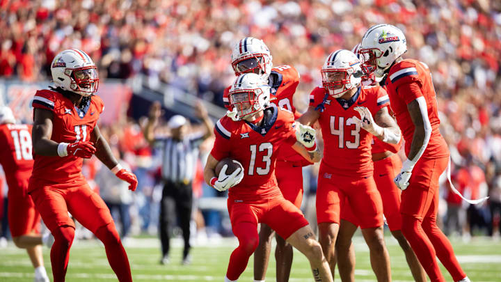 Oct 19, 2024; Tucson, Arizona, USA; Arizona Wildcats defensive back Jack Luttrell (13) celebrates with teammates against the Colorado Buffalos at Arizona Stadium. Mandatory Credit: Mark J. Rebilas-Imagn Images
