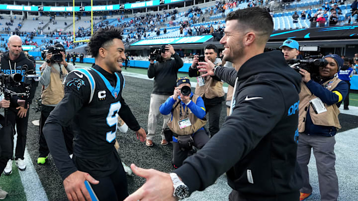 Carolina Panthers head coach Dave Canales celebrates with quarterback Bryce Young 