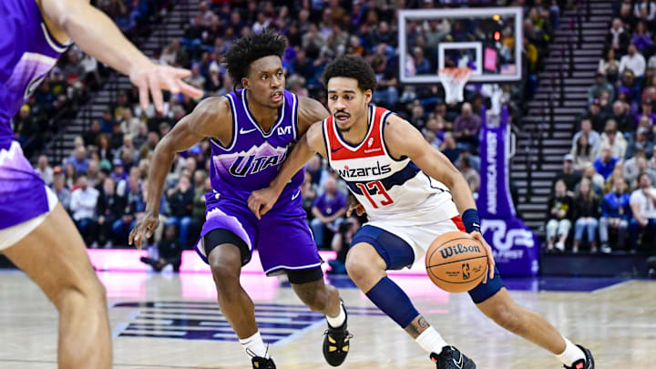 Mar 4, 2024; Salt Lake City, Utah, USA; Washington Wizards guard Jordan Poole (13) drives around Utah Jazz guard Collin Sexton (2) during the first half at the Delta Center. Mandatory Credit: Christopher Creveling-Imagn Images
