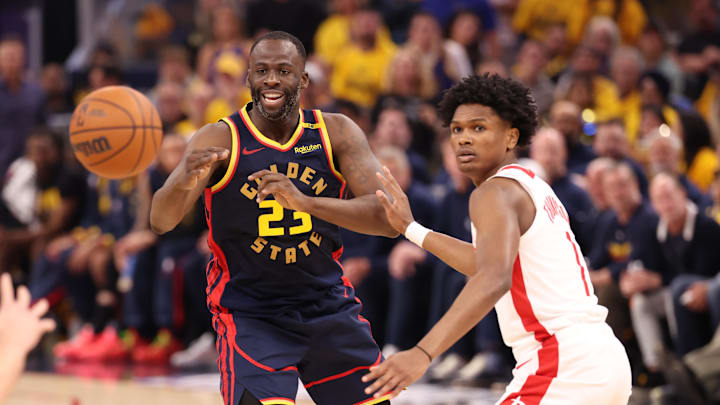 Apr 28, 2025; San Francisco, California, USA; Golden State Warriors forward Draymond Green (23) passes the ball against Houston Rockets forward/guard Amen Thompson (1) during the second quarter of game four of the 2025 NBA Playoffs first round at Chase Center. Mandatory Credit: Kelley L Cox-Imagn Images
