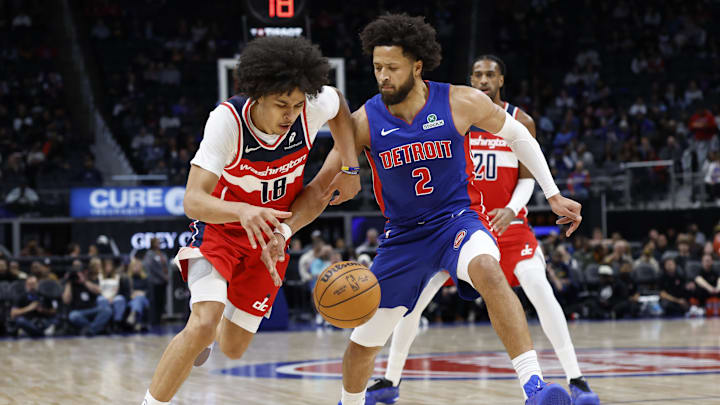 Nov 10, 2025; Detroit, Michigan, USA;  Washington Wizards forward Kyshawn George (18) dribbles defended by Detroit Pistons guard Cade Cunningham (2) in the first half at Little Caesars Arena. Mandatory Credit: Rick Osentoski-Imagn Images