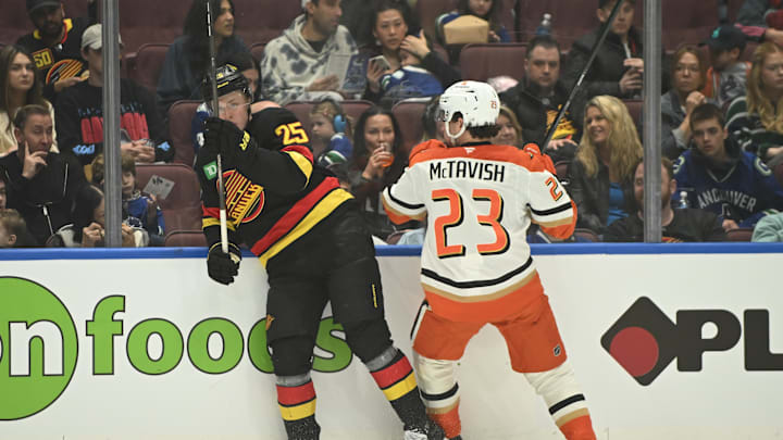 Apr 5, 2025; Vancouver, British Columbia, CAN;  Anaheim Ducks forward Mason McTavish (23) checks Vancouver Canucks defenseman Elias Pettersson (25) during the first period at Rogers Arena. Mandatory Credit: Anne-Marie Sorvin-Imagn Images