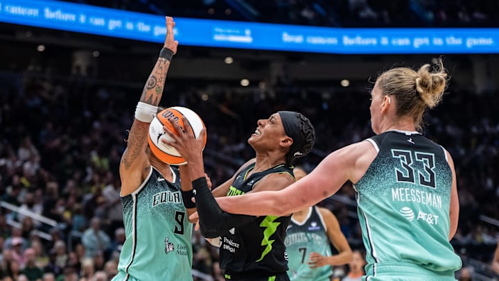 Sep 5, 2025; Seattle, Washington, USA;  Seattle Storm guard Brittney Sykes (20) goes up for a shot against New York Liberty guard Natasha Cloud (9) and center Emma Meesseman (33) during the second half at Climate Pledge Arena. Mandatory Credit: Stephen Brashear-Imagn Images