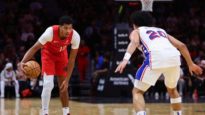 Nov 18, 2024; Miami, Florida, USA; Miami Heat guard Dru Smith (12) dribbles the basketball as Philadelphia 76ers guard Jared McCain (20) defends during the second quarter at Kaseya Center. Mandatory Credit: Sam Navarro-Imagn Images
