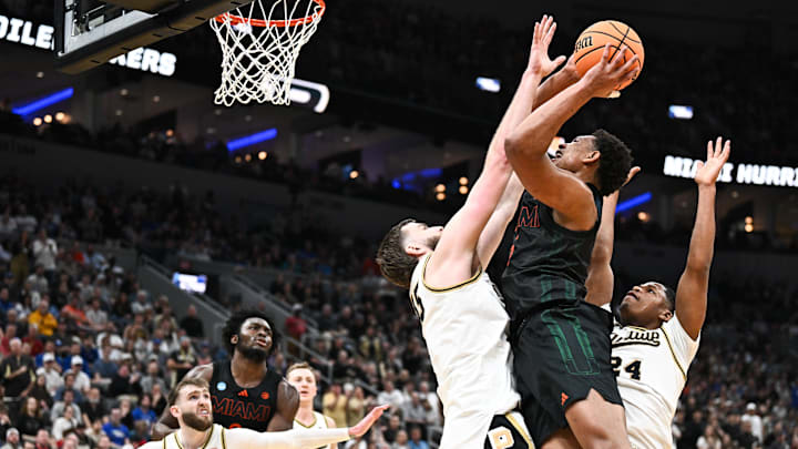 Mar 22, 2026; St. Louis, MO, USA; Miami Hurricanes forward Malik Reneau (5) shoots as Purdue Boilermakers center Oscar Cluff (45) defends during the second half during a second round game of the men's 2026 NCAA Tournament at Enterprise Center. Mandatory Credit: Jeff Le-Imagn Images