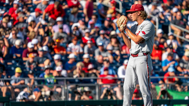 Jun 22, 2022; Omaha, NE, USA; Arkansas Razorbacks starting pitcher Hagen Smith (33) pitches against the Ole Miss Rebels during the first inning at Charles Schwab Field. Mandatory Credit: Dylan Widger-USA TODAY Sports