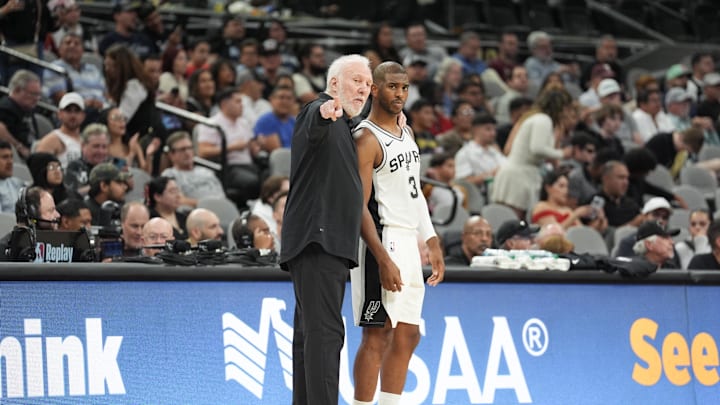 Oct 9, 2024; San Antonio, Texas, USA;  San Antonio Spurs head coach Gregg Popovich talks with guard Chris Paul (3) in the first half against the Orlando Magic  at Frost Bank Center. Mandatory Credit: Daniel Dunn-Imagn Images