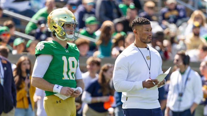 Quarterback Steve Angeli (18) stands alongside head coach Marcus Freeman during the Blue-Gold game at Notre Dame Stadium. 