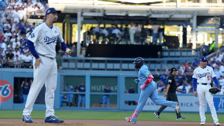 Oct 29, 2025; Los Angeles, California, USA; Toronto Blue Jays first baseman Vladimir Guerrero Jr. (27) runs the bases after hitting a home run in the first inning as Los Angeles Dodgers starting pitcher Blake Snell (7) and first baseman Freddie Freeman (5) watch during game five of the 2025 MLB World Series at Dodger Stadium. Mandatory Credit: Kirby Lee-Imagn Images