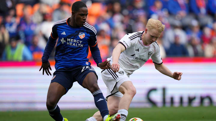 FC Cincinnati midfielder Malik Pinto (26) and D.C. United defender Matti Peltola (4) compete for possession in the second half of an MLS soccer match, Sunday, March 10, 2024, at TQL Stadium in Cincinnati.