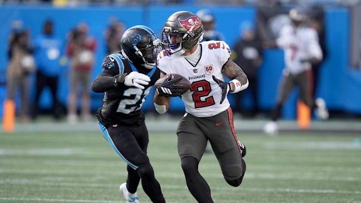 Dec 21, 2025; Charlotte, North Carolina, USA; Tampa Bay Buccaneers wide receiver Emeka Egbuka (2) runs against Carolina Panthers safety Nick Scott (21) during the second half at Bank of America Stadium. Mandatory Credit: Jim Dedmon-Imagn Images