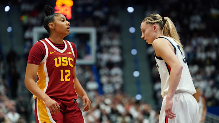 Dec 21, 2024; Hartford, Connecticut, USA; UConn Huskies guard Paige Bueckers (5) and USC Trojans guard JuJu Watkins (12) on the court in the first half at XL Center. Mandatory Credit: David Butler II-Imagn Images Dec 21, 2024; Hartford, Connecticut, USA; UConn Huskies guard Paige Bueckers (5) and USC Trojans guard JuJu Watkins (12) on the court in the first half at XL Center. Mandatory Credit: David Butler II-Imagn Images