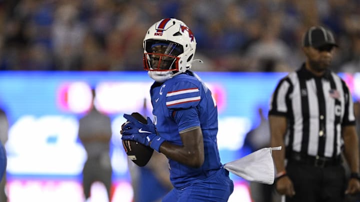 Nov 2, 2024; Dallas, Texas, USA; Southern Methodist Mustangs quarterback Kevin Jennings (7) drops back to pass against the Pittsburgh Panthers during the first half at Gerald J. Ford Stadium. Mandatory Credit: Jerome Miron-Imagn Images