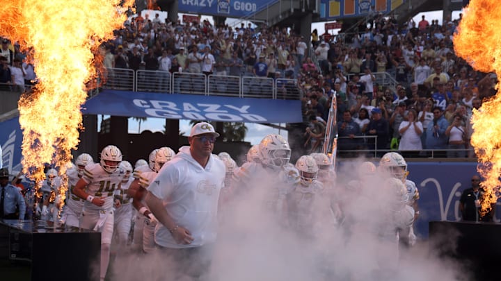 Dec 27, 2025; Orlando, FL, USA; Georgia Tech Yellow Jackets head coach Brent Key and teammates run out of the tunnel as they are introduced against the BYU Cougars at Camping World Stadium. Mandatory Credit: Kim Klement Neitzel-Imagn Images Dec 27, 2025; Orlando, FL, USA; Georgia Tech Yellow Jackets head coach Brent Key and teammates run out of the tunnel as they are introduced against the BYU Cougars at Camping World Stadium. Mandatory Credit: Kim Klement Neitzel-Imagn Images