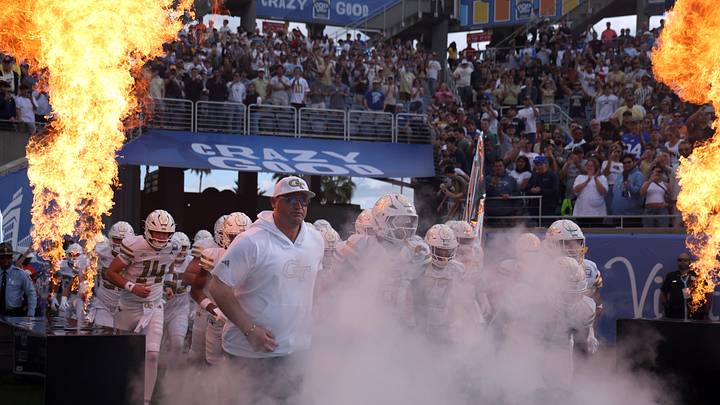 Dec 27, 2025; Orlando, FL, USA; Georgia Tech Yellow Jackets head coach Brent Key and teammates run out of the tunnel as they are introduced against the BYU Cougars at Camping World Stadium. Mandatory Credit: Kim Klement Neitzel-Imagn Images Dec 27, 2025; Orlando, FL, USA; Georgia Tech Yellow Jackets head coach Brent Key and teammates run out of the tunnel as they are introduced against the BYU Cougars at Camping World Stadium. Mandatory Credit: Kim Klement Neitzel-Imagn Images