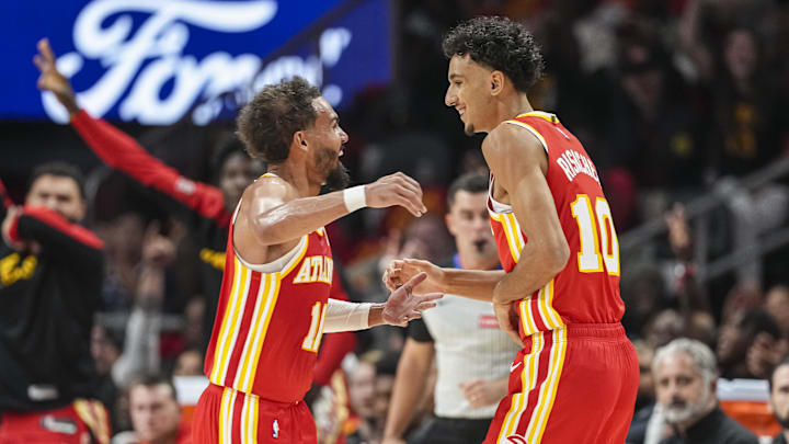 Oct 23, 2024; Atlanta, Georgia, USA; Atlanta Hawks forward Zaccharie Risacher (10) reacts with guard Trae Young (11) after making a three point basket for his first points in the NBA against the Brooklyn Nets during the first half at State Farm Arena. Mandatory Credit: Dale Zanine-Imagn Images Oct 23, 2024; Atlanta, Georgia, USA; Atlanta Hawks forward Zaccharie Risacher (10) reacts with guard Trae Young (11) after making a three point basket for his first points in the NBA against the Brooklyn Nets during the first half at State Farm Arena. Mandatory Credit: Dale Zanine-Imagn Images