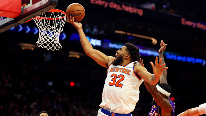 Nov 20, 2024; Phoenix, Arizona, USA; New York Knicks center Karl-Anthony Towns (32) shoots the ball against Phoenix Suns forward Royce O'Neale (00) during the fourth quarter at Footprint Center. Mandatory Credit: Mark J. Rebilas-Imagn Images