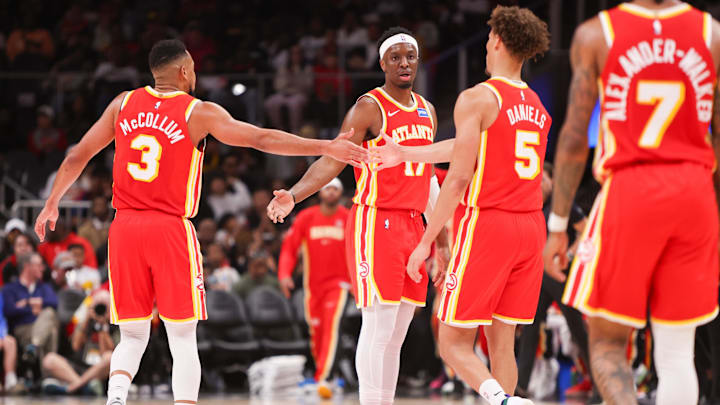 Mar 14, 2026; Atlanta, Georgia, USA; Atlanta Hawks guard CJ McCollum (3) and forward Onyeka Okongwu (17) and guard Dyson Daniels (5) during a timeout against the Milwaukee Bucks in the third quarter at State Farm Arena. Mandatory Credit: Brett Davis-Imagn Images