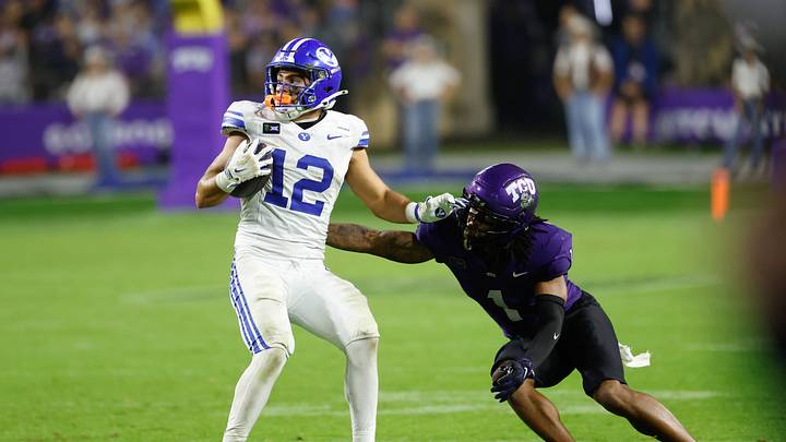 Oct 3, 2026; Fort Worth, Texas, USA;  BYU Cougars running back Preston Rex (12) runs after a catch against TCU Horned Frogs cornerback Vernon Glover, Jr. (1) during the second half at Amon G. Carter Stadium.  Mandatory Credit: Chris Jones-Imagn Images