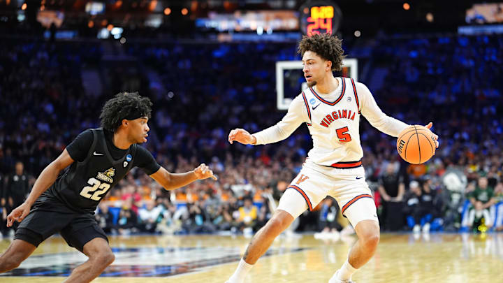 Mar 20, 2026; Philadelphia, PA, USA; Virginia Cavaliers guard Sam Lewis (5) dribbles as Wright State Raiders guard TJ Burch (22) defends during the second half during a first round game of the men's 2026 NCAA Tournament at Xfinity Mobile Arena. Mandatory Credit: Kyle Ross-Imagn Images