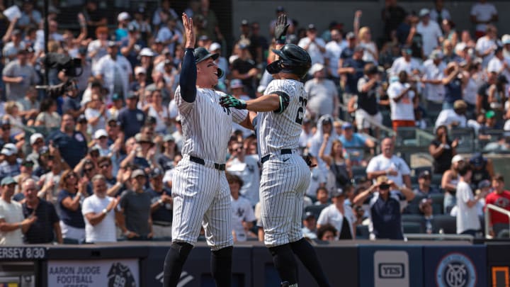 Aug 11, 2024; Bronx, New York, USA; New York Yankees designated hitter Giancarlo Stanton (27) celebrates after hitting a three run home run with center fielder Aaron Judge (99) during the fifth inning against the Texas Rangers at Yankee Stadium. Mandatory Credit: Vincent Carchietta-USA TODAY Sports Aug 11, 2024; Bronx, New York, USA; New York Yankees designated hitter Giancarlo Stanton (27) celebrates after hitting a three run home run with center fielder Aaron Judge (99) during the fifth inning against the Texas Rangers at Yankee Stadium. Mandatory Credit: Vincent Carchietta-USA TODAY Sports