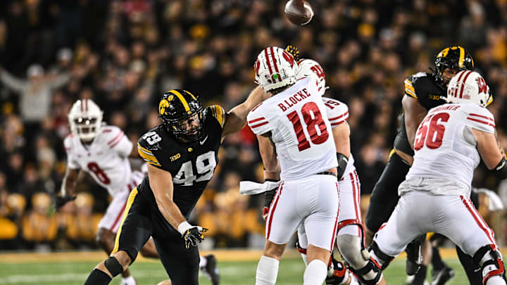 Nov 2, 2024; Iowa City, Iowa, USA; Iowa Hawkeyes defensive lineman Ethan Hurkett (49) rushes towards Wisconsin Badgers quarterback Braedyn Locke (18) during the second quarter at Kinnick Stadium. Mandatory Credit: Jeffrey Becker-Imagn Images