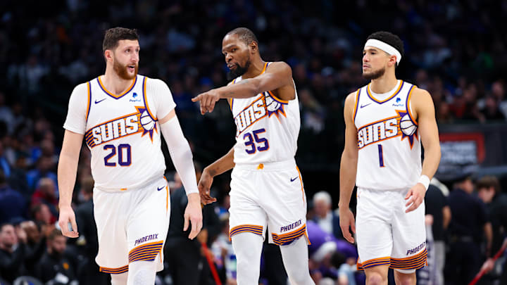 Jan 24, 2024; Dallas, Texas, USA;  Phoenix Suns forward Kevin Durant (35) and Phoenix Suns guard Devin Booker (1) and Phoenix Suns center Jusuf Nurkic (20) talk during the third quarter against the Dallas Mavericks at American Airlines Center. Mandatory Credit: Kevin Jairaj-Imagn Images