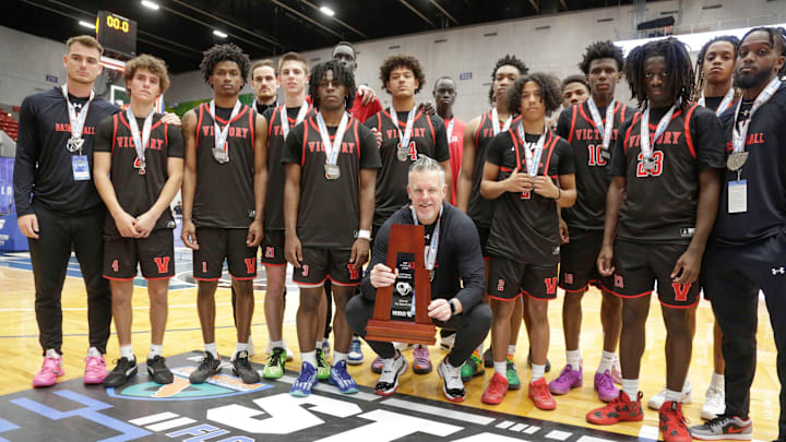 Victory Christian with their 1A State Runner Up trophy held by coach Steve Fitzgerald. Lakeland’s Victory Christian HS vs Weston’s Sagemont HS FHSAA 1A State Boys basketball Championship game at the RP Funding Center in Lakeland Fl. February 27th 2025. Photos special to the Ledger / Calvin Knight