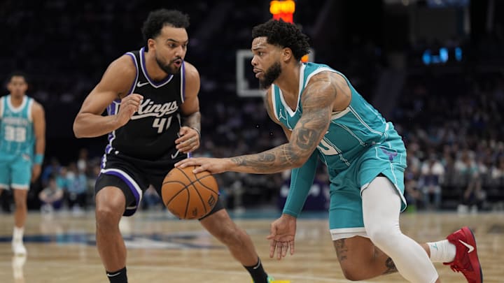 Apr 4, 2025; Charlotte, North Carolina, USA; Charlotte Hornets forward Miles Bridges (0) drives to the basket against Sacramento Kings forward Trey Lyles (41) during the second half at Spectrum Center. Mandatory Credit: Jim Dedmon-Imagn Images