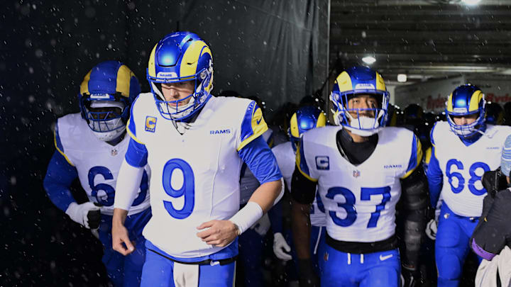 Jan 18, 2026; Chicago, IL, USA; Los Angeles Rams quarterback Matthew Stafford (9), guard Kevin Dotson (69), safety Quentin Lake (37) and offensive tackle David Quessenberry (68) run onto the field before an NFC Divisional Round game against the Chicago Bears at Soldier Field. Mandatory Credit: Matt Marton-Imagn Images