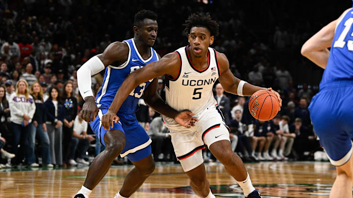 Nov 15, 2025; Boston, Massachusetts, USA; UConn Huskies forward Tarris Reed Jr. (5) drives to the basket against BYU Cougars center Keba Keita (13) during the first half at TD Garden. Mandatory Credit: Eric Canha-Imagn Images