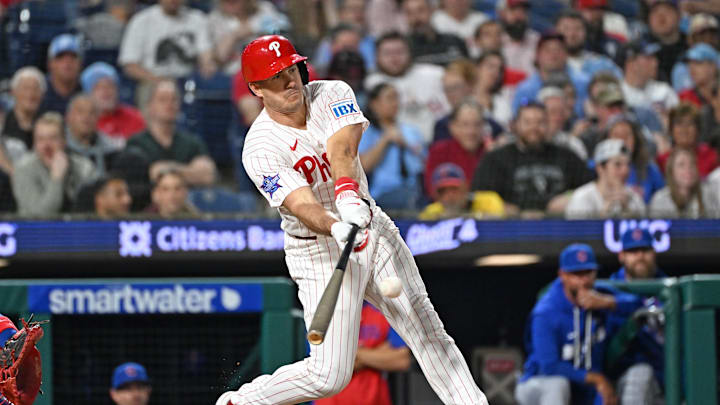 Apr 13, 2026; Philadelphia, Pennsylvania, USA; Philadelphia Phillies catcher J.T. Realmuto (10) hits an RBI single Chicago Cubs during the sixth inning at Citizens Bank Park. 