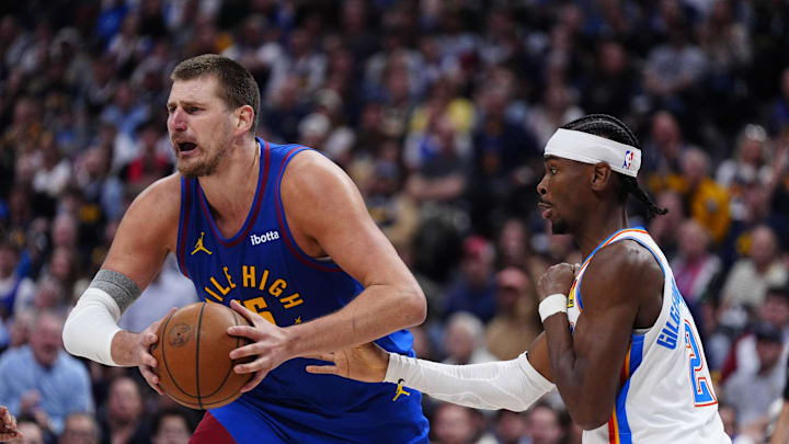 May 9, 2025; Denver, Colorado, USA; Oklahoma City Thunder guard Shai Gilgeous-Alexander (2) defends on Denver Nuggets center Nikola Jokic (15) in the second half during game three of the second round for the 2025 NBA Playoffs at Ball Arena. Mandatory Credit: Ron Chenoy-Imagn Images