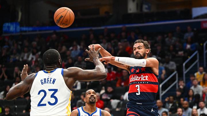 Mar 16, 2026; Washington, District of Columbia, USA; Washington Wizards guard Trae Young (3) passes between Golden State Warriors guard De'anthony Melton (8) and forward Draymond Green (23) during the first half at Capital One Arena. Mandatory Credit: Brad Mills-Imagn Images Mar 16, 2026; Washington, District of Columbia, USA; Washington Wizards guard Trae Young (3) passes between Golden State Warriors guard De'anthony Melton (8) and forward Draymond Green (23) during the first half at Capital One Arena. Mandatory Credit: Brad Mills-Imagn Images